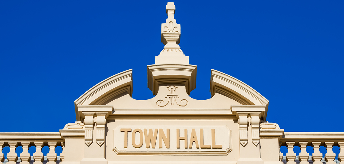 Close up of the word's 'Town Hall', which are visible on the top of the building's exterior
