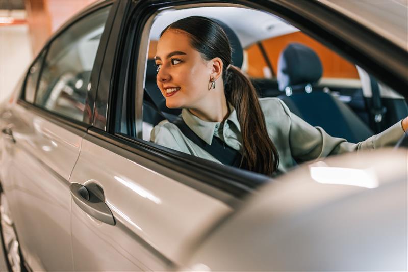 Woman in car with window open in car park