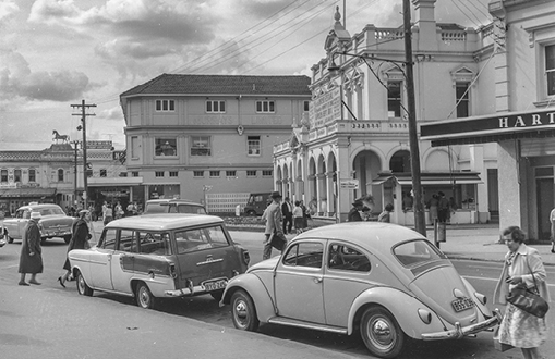 Historical black and white image of cars parked in the streets of Parramatta