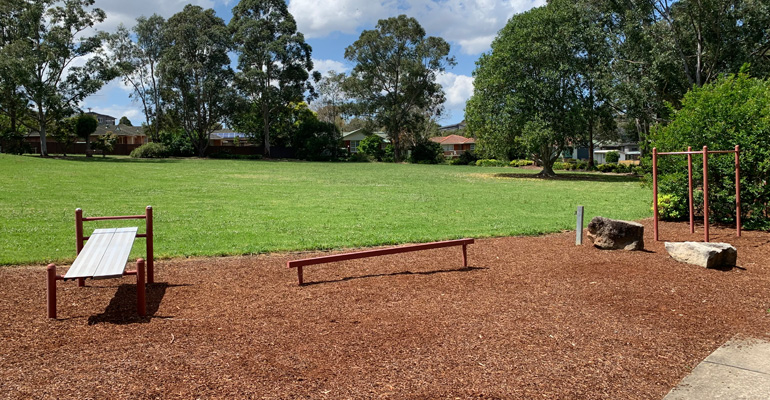 Park with exercise bench, walking beam and bars