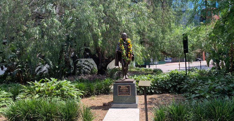 Mahatma Gandhi bronze statue with flower garlands around neck