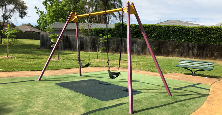 Swings with grass in background