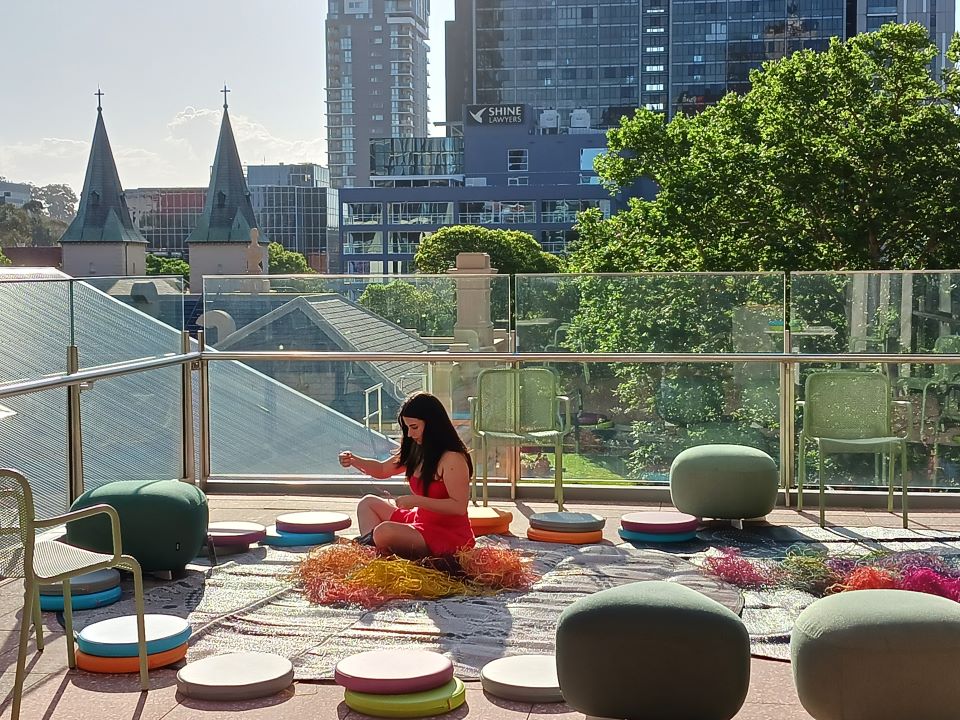 Girl sitting in corner of balcony