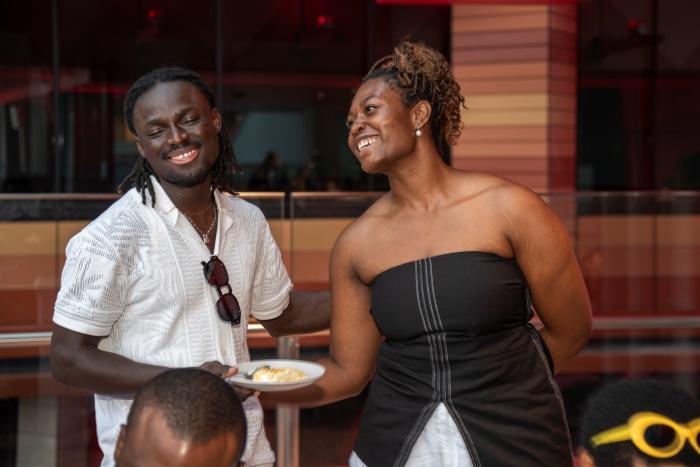 Man and woman smiling and holding plate