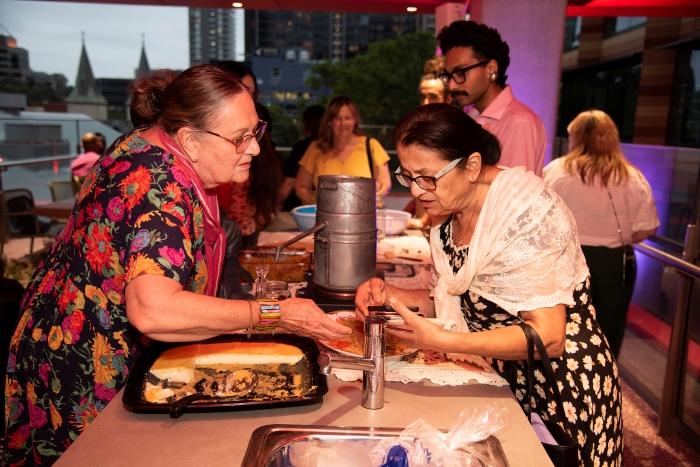 Two women talking over food