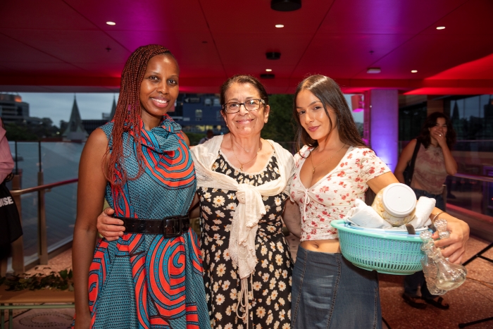 Three women with arms around each other