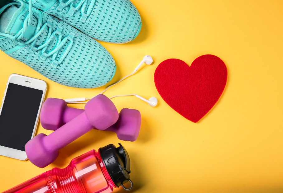flat lay of phone, weights, mobile phone, running shoes, water bottle against yellow background