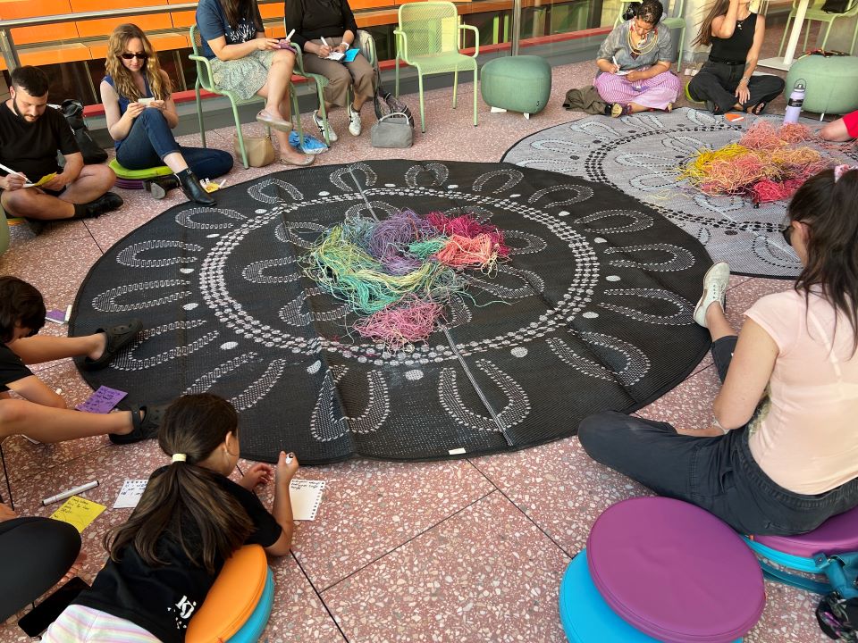 People sitting around a mat