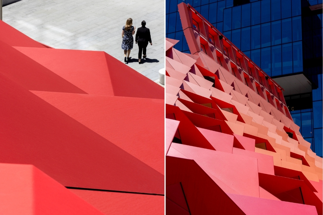 Split image of modern red architecture. Left: a vast, angular red structure with two people walking on a light pavement. Right: a dynamic facade of interlocking red panels on a glass building. The tone is modern and vibrant.