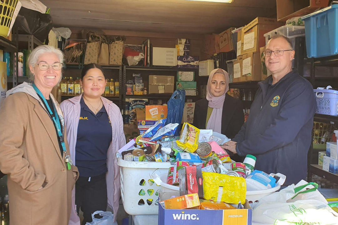 Women and Men in front of food baskets