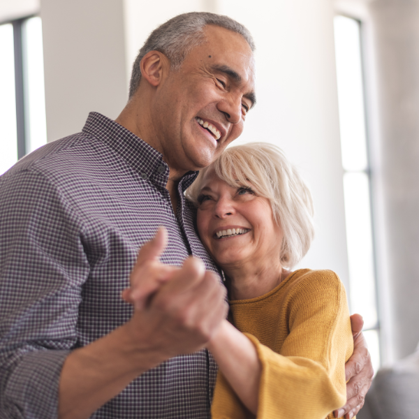 Older couple smiling and dancing