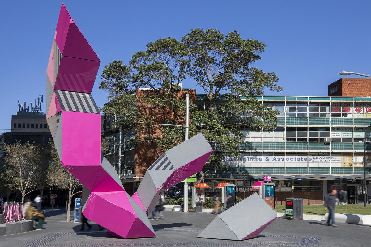 Pink and grey sculpture made out of aluminium, granite and LED lighting.
