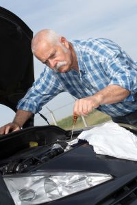 older man working on car