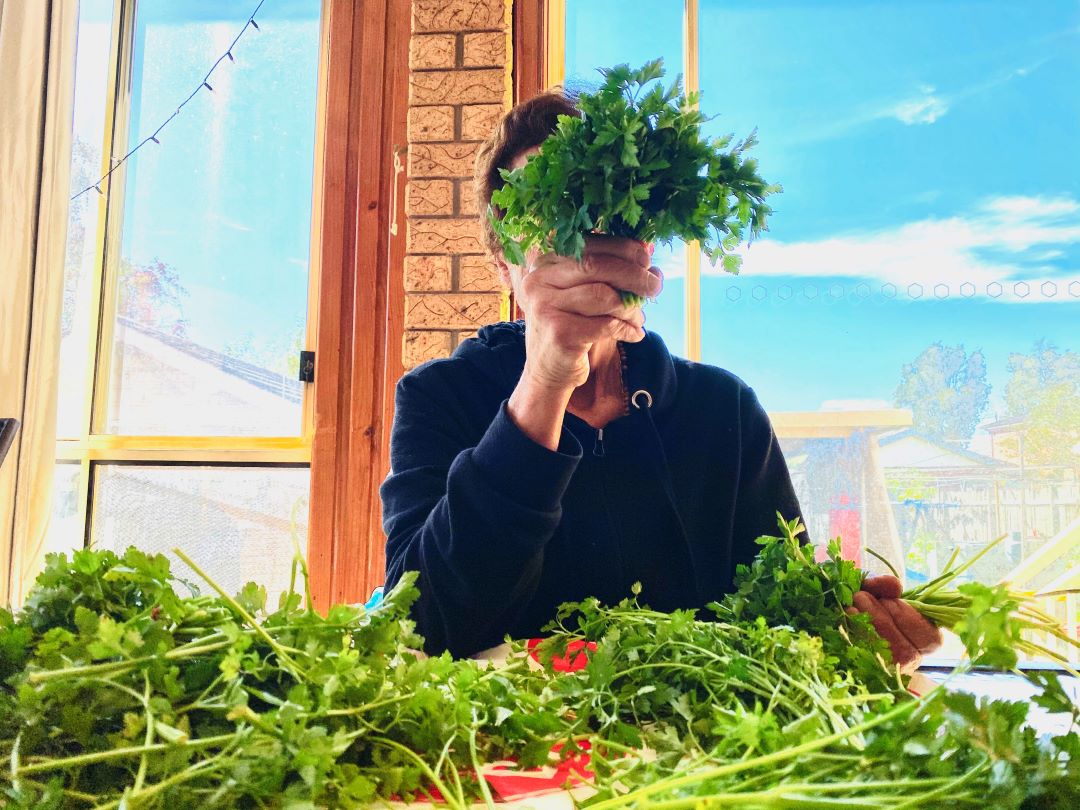 Lady with herbs covering face