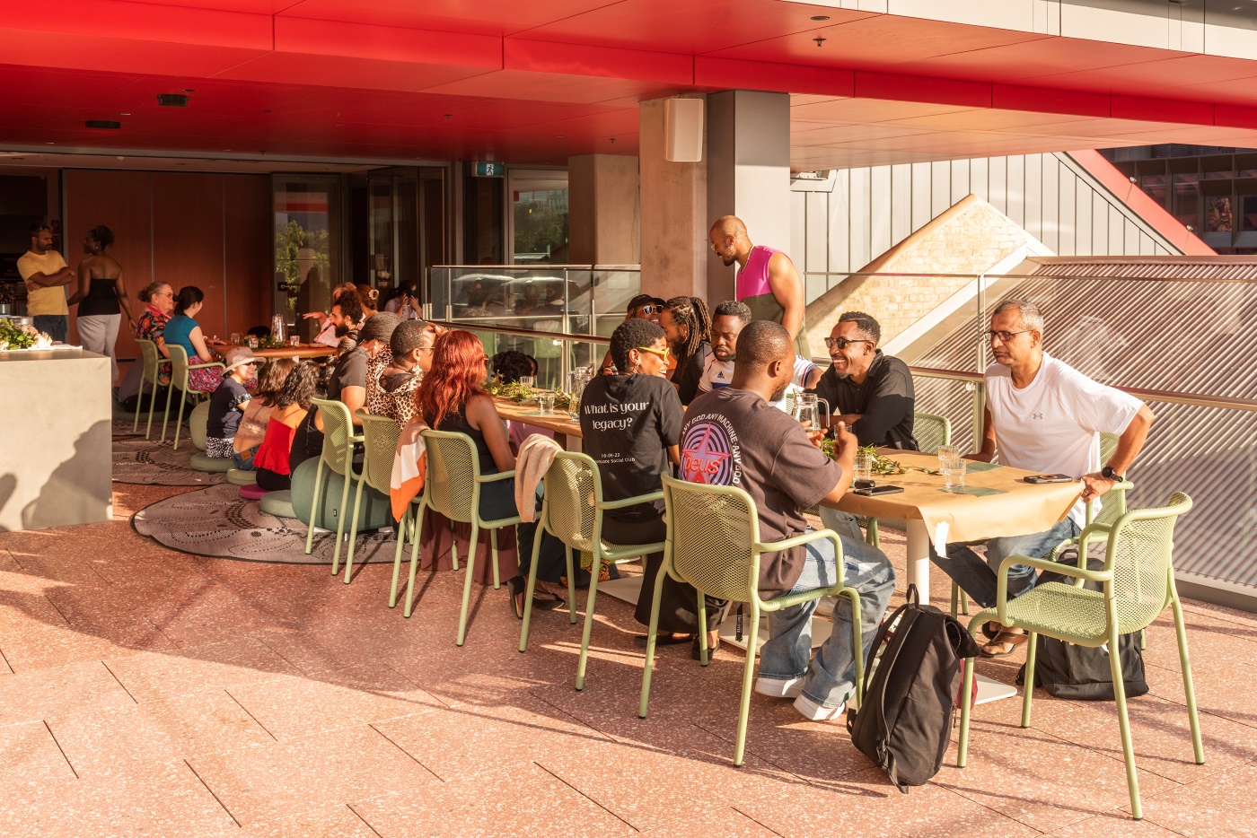 Photo taken from the side of group of people sitting at a table on the Western Terrace