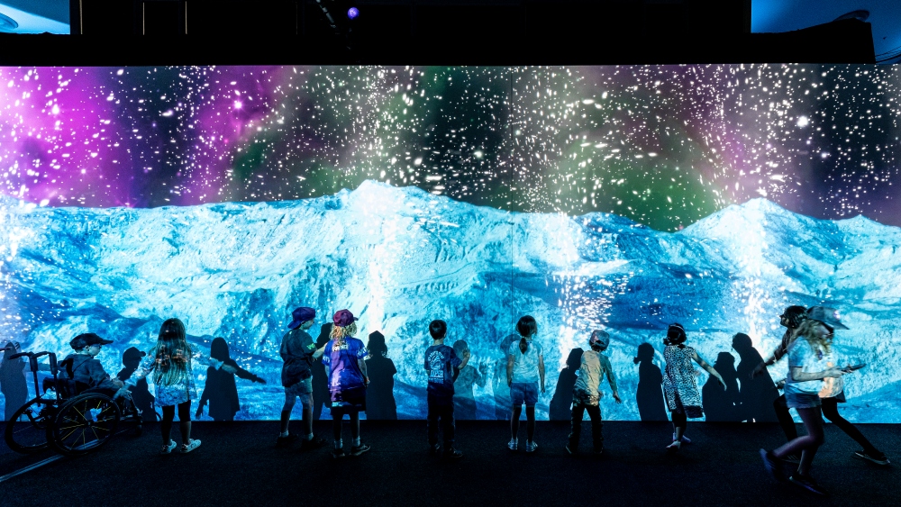 Children standing in front of Space Play by Box of Birds