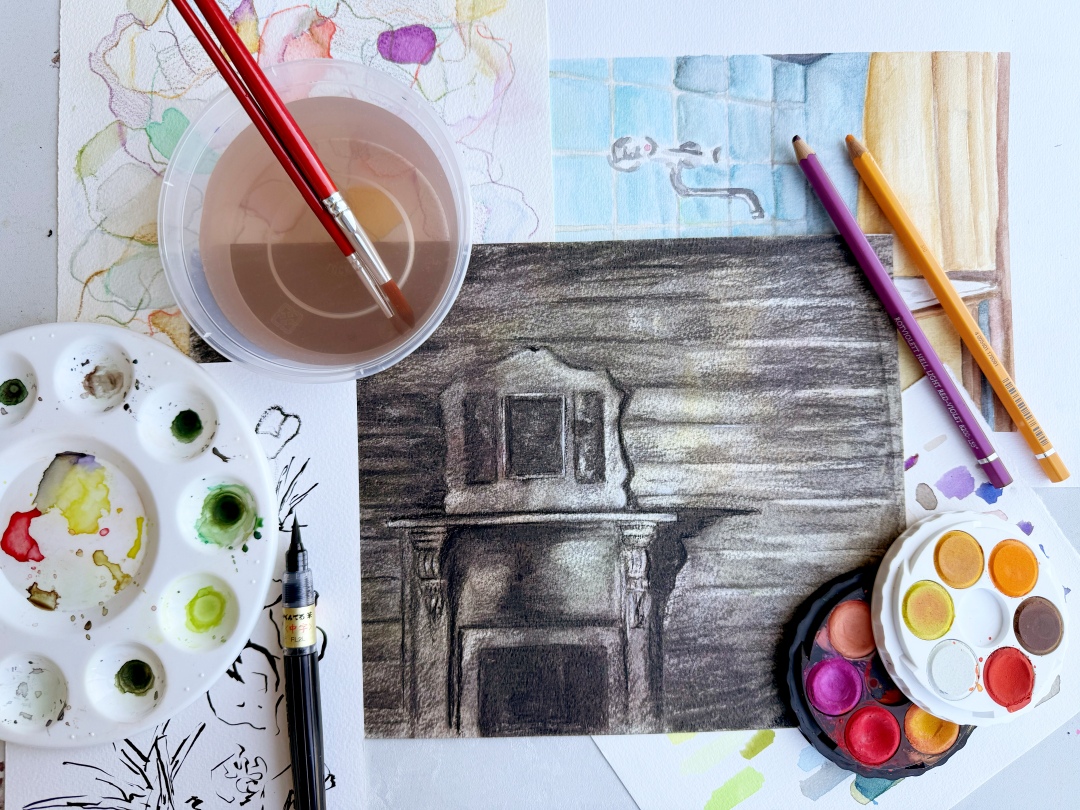 Art supplies and sketches displayed on a table. A watercolor palette, colored pencils, and paintbrushes surround a charcoal drawing of a mantle. Colourful and creative atmosphere.