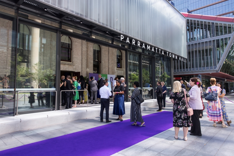 People talking around purple carpet outside of Parramatta Town Hall