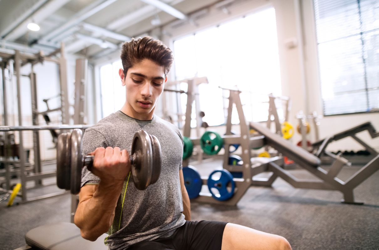 Teenage boy lifting weights